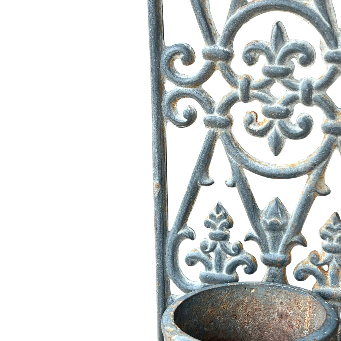 close up of a metal decorative wall planter on a white background