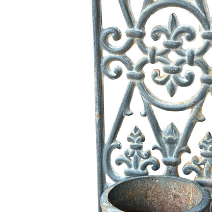 close up of a metal decorative wall planter on a white background