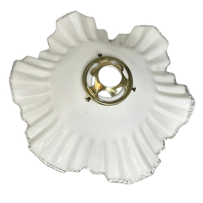 White glass lamp shade with scalloped edge on a white background