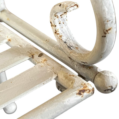 Close-up of a metal she with visible wear and tear on a white background