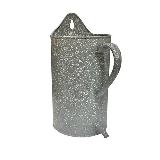 A grey enamel planter with a speckled grey finish, featuring a carrying loop at the top, a side handle, and a small spout at the bottom, shown against a plain white background.