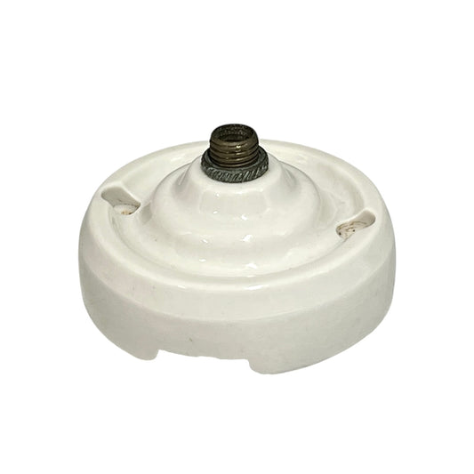Small vintage French porcelain ceiling rose with a brass nut on a white background 
