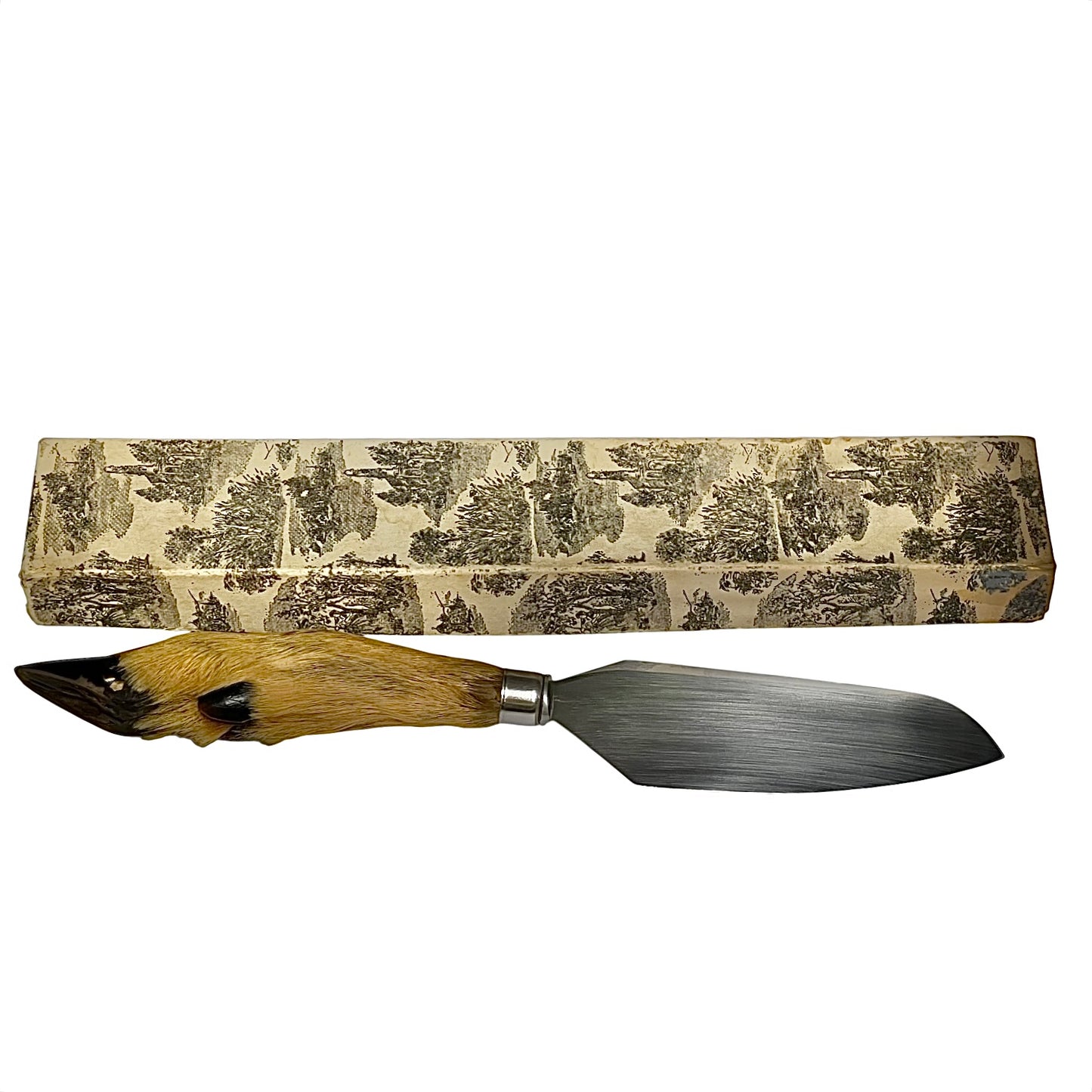A decorative cake slice with a natural brown animal fur handle and a steel blade, displayed horizontally below its matching patterned presentation box on a white background