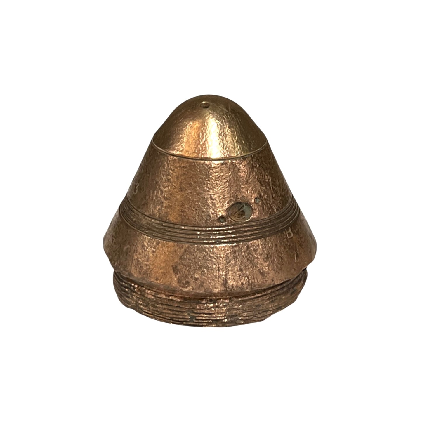 A small militaria WW1 brass fuse paperweight with a textured finish on a white background 