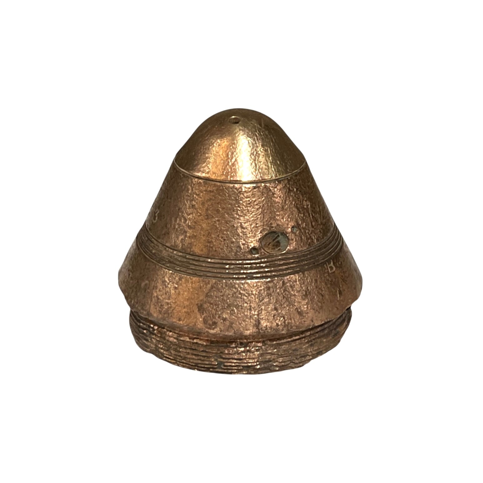 A small militaria WW1 brass fuse paperweight with a textured finish on a white background 