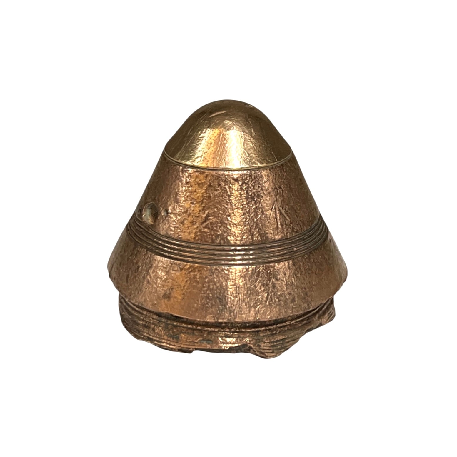 A small WW1 brass British fuse paperweight with a textured finish on a white background 
