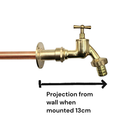 A brass wall-mounted tap with a copper pipe connection, shown on a white background with a black measurement arrow and text indicating a 13 cm projection when mounted.
