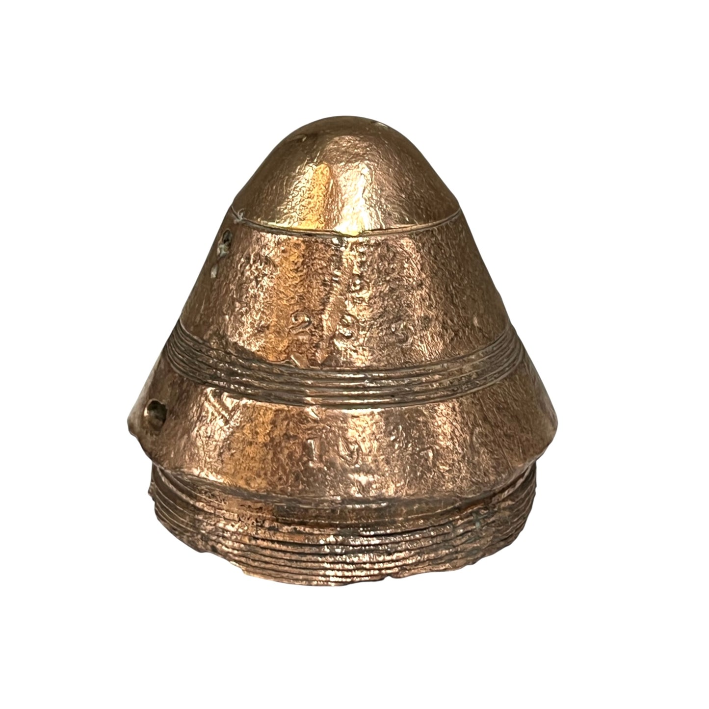 A small WW1 brass fuse paperweight with a textured finish shown on a white background 
