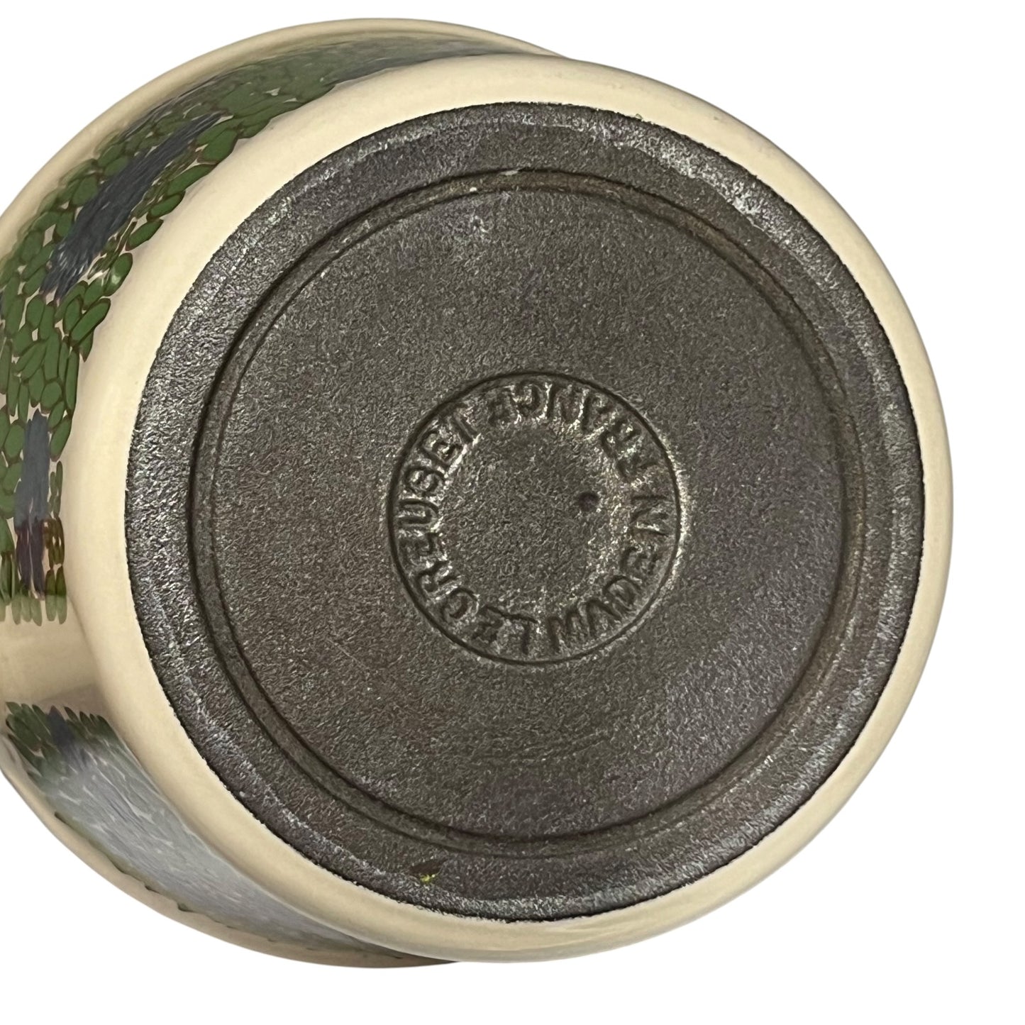 Base view of a le Creuset pan showing the makers mark on a white background 