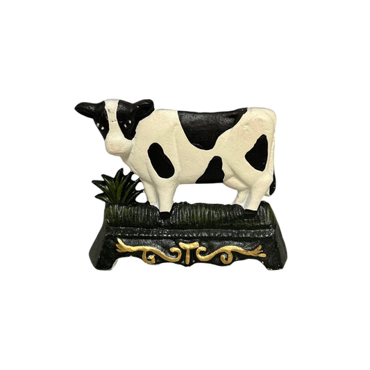 A small cast iron doorstop shaped like a cow, perfect for adding charm to a country cottage or farmhouse, set against a white background.