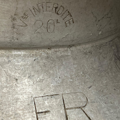 Close up of a vintage metal milk churn on a white background