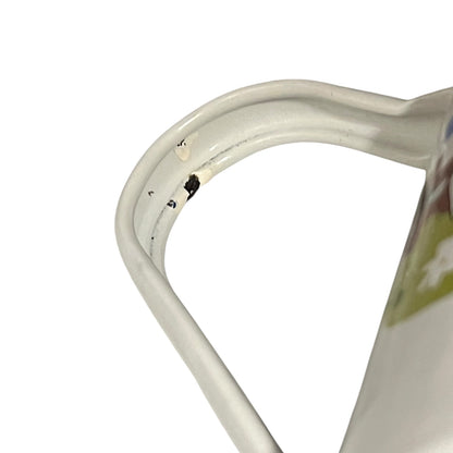 Close up of a French enamel coffee pot on a white background