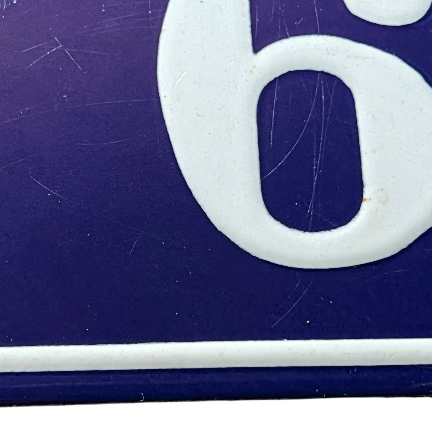 Close-up of a white number '6' on a blue background