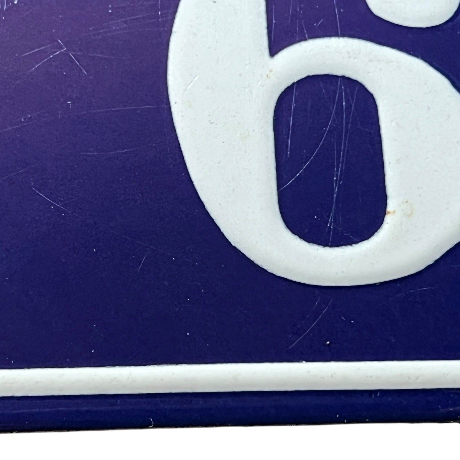 Close-up of a white number '6' on a blue background