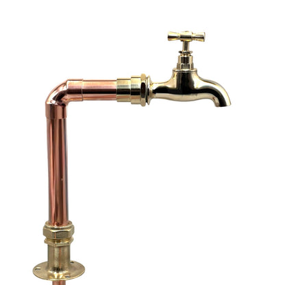copper and brass pillar tap on a white background
