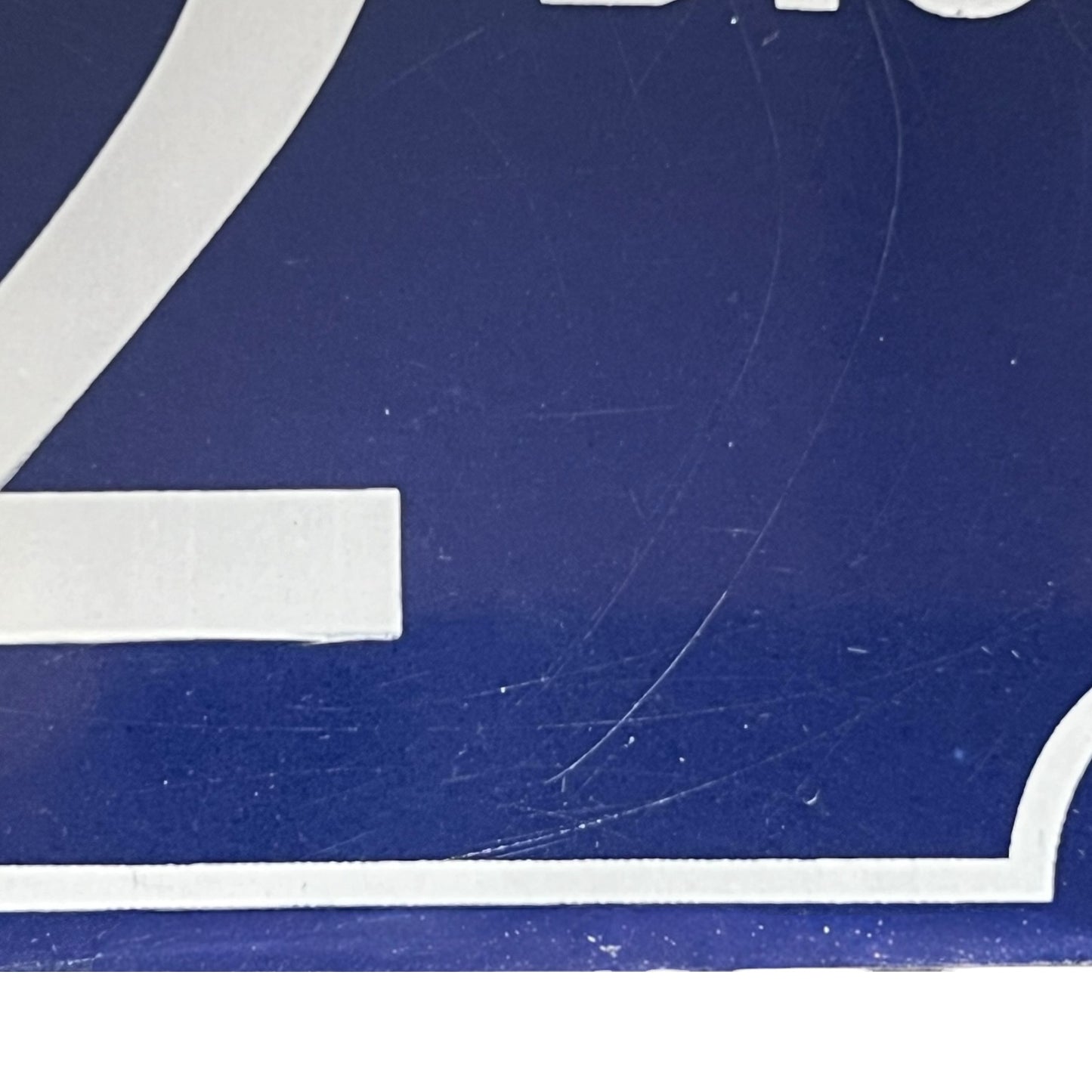 Close up of a French enamel door number 32 on a white background 