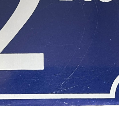 Close up of a French enamel door number 32 on a white background 