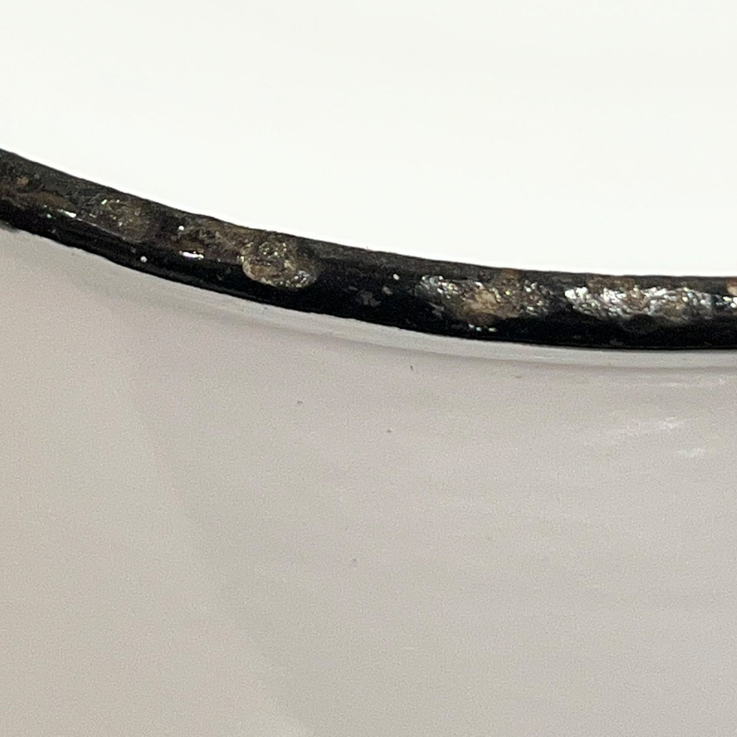 Close up of an enamel coffee pot on a white background