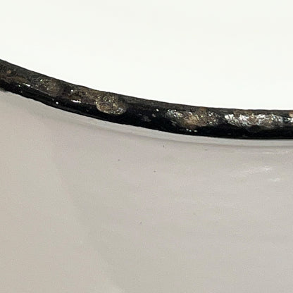 Close up of an enamel coffee pot on a white background