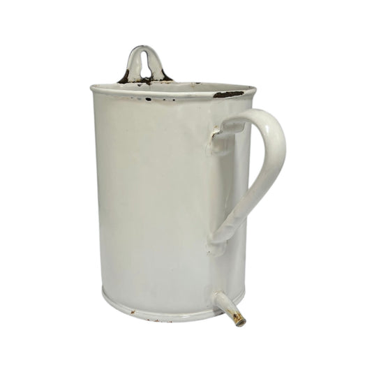 White enamel vintage French irrigator now repurposed as a garden planter with a spout and a hanging hook on a white background
