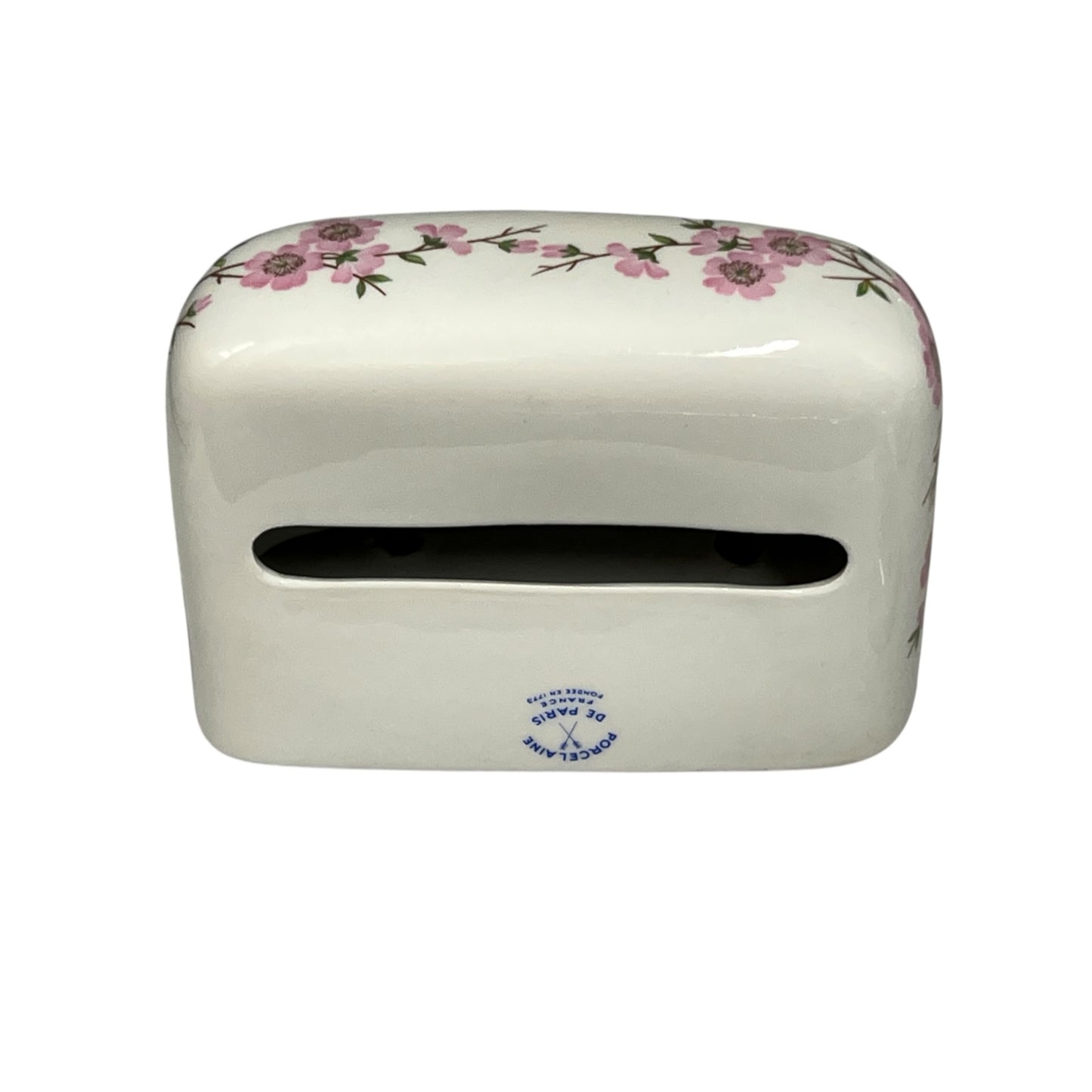 A white ceramic tissue holder with a pink floral pattern along the top edge and a small blue printed logo near the bottom front, shown on a plain white background.