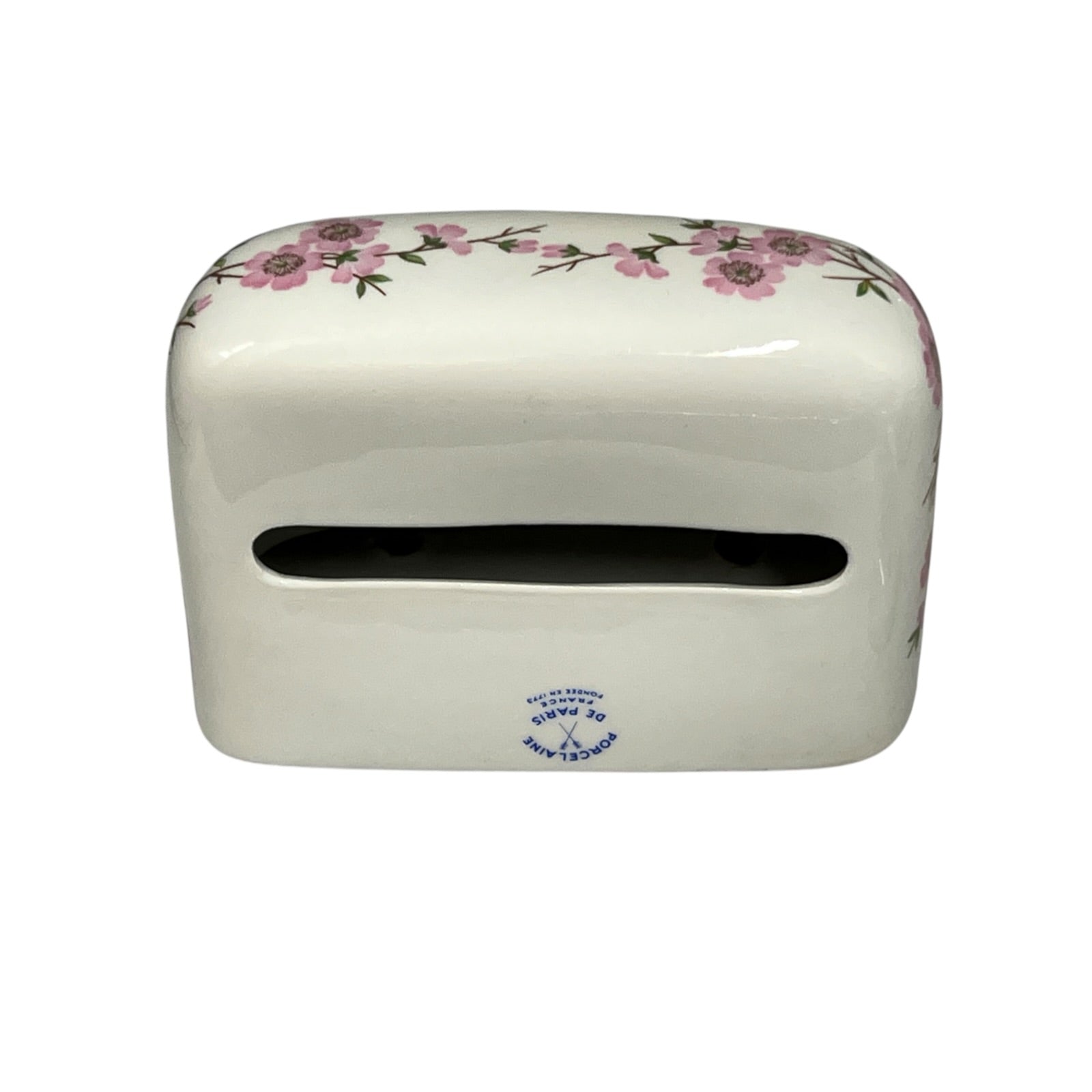 A white ceramic tissue holder with a pink floral pattern along the top edge and a small blue printed logo near the bottom front, shown on a plain white background.