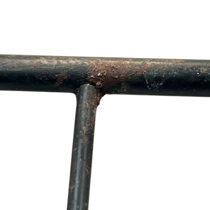 Close-up of a black metal stand on a white background