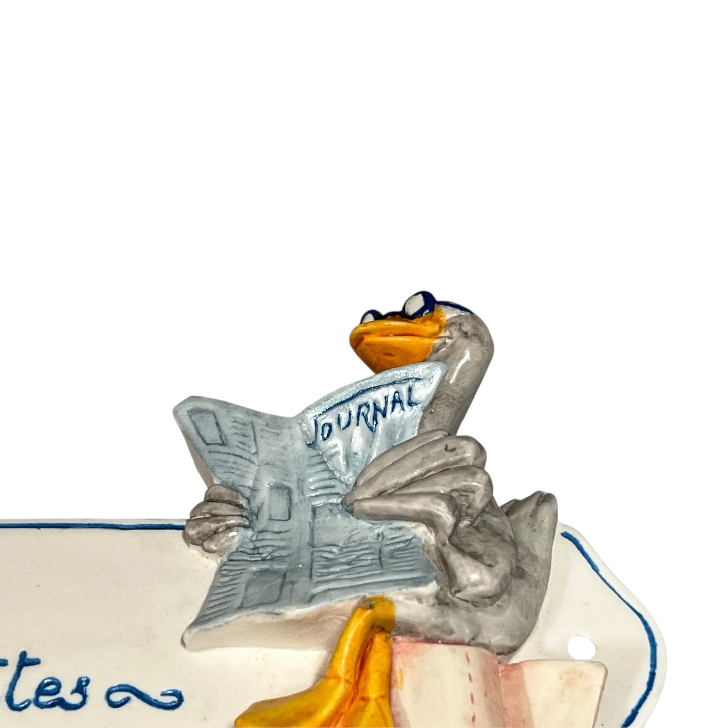 Decorative novelty door sign for a toilet labelled in French as Toilettes, with a goose reading a newspaper  decoration on a white background