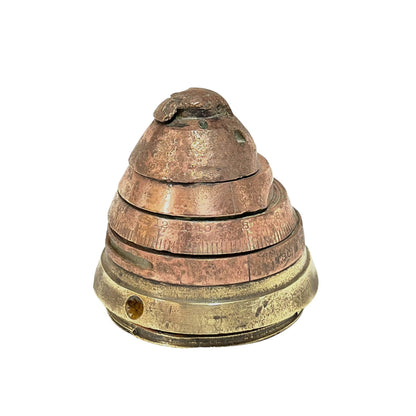 WW1 brass fuse paperweight on a white background