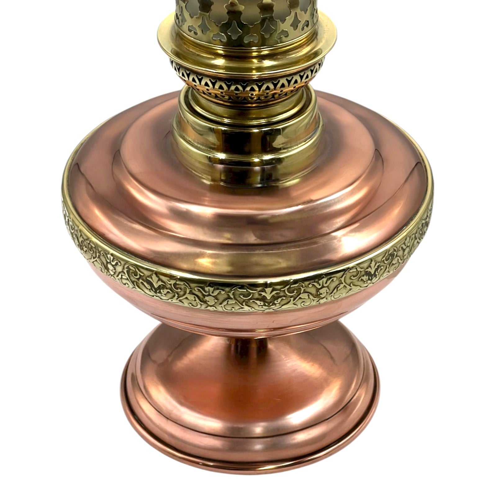 Decorative copper and brass lamp base on a white background
