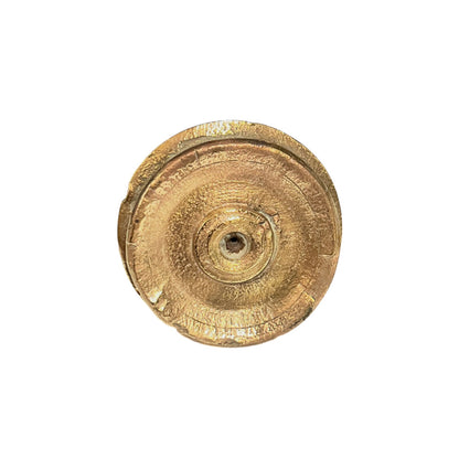 A circular, textured gold-colored metal component or hardware piece, photographed from directly above on a solid white background.