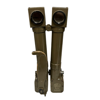 A pair of military-style binoculars in olive drab green, folded vertically with a carrying handle and adjustment knobs, shown against a plain white background.