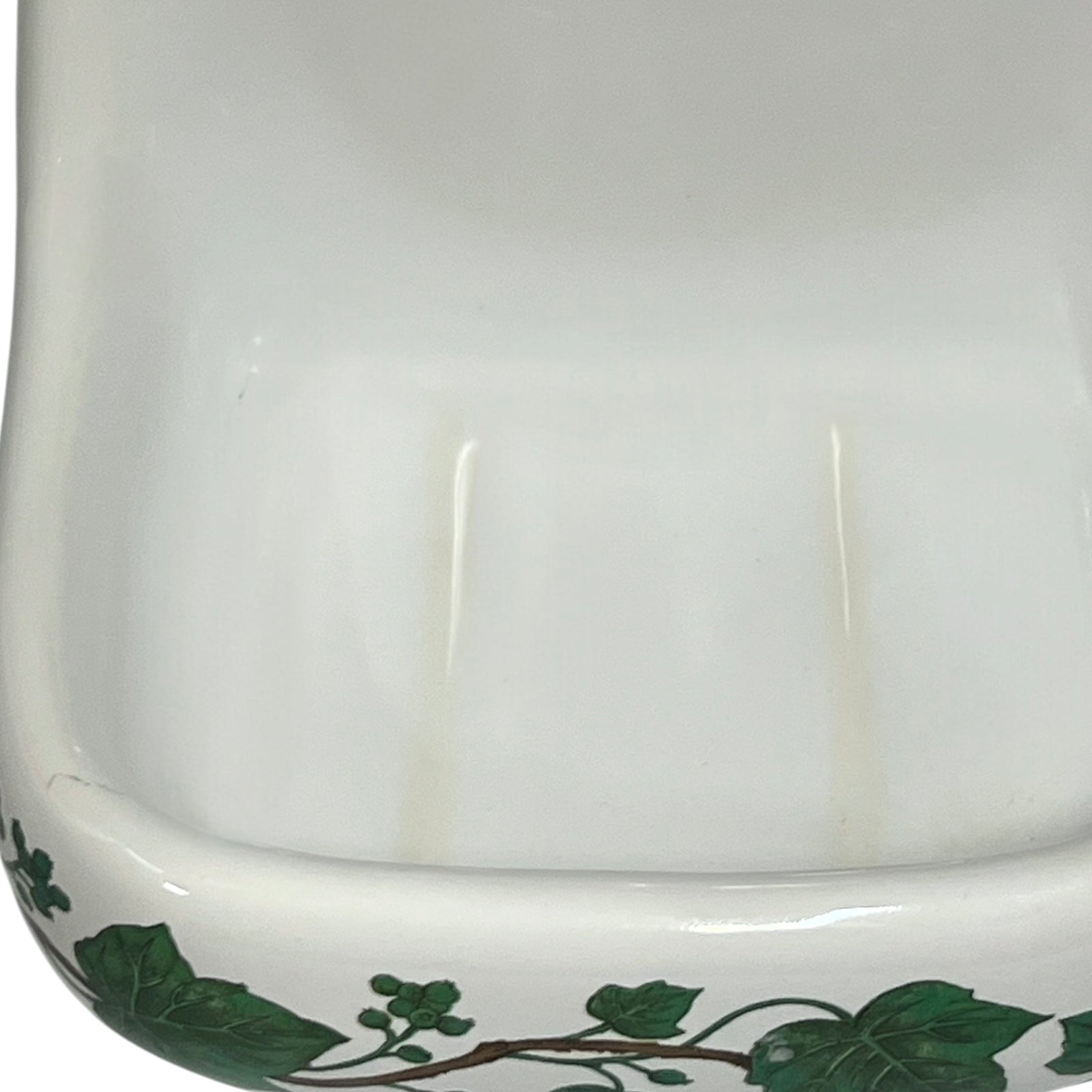 Porcelain bathroom soap dish  featuring green leaf patterns on a white background
