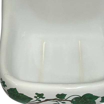 Porcelain bathroom soap dish  featuring green leaf patterns on a white background