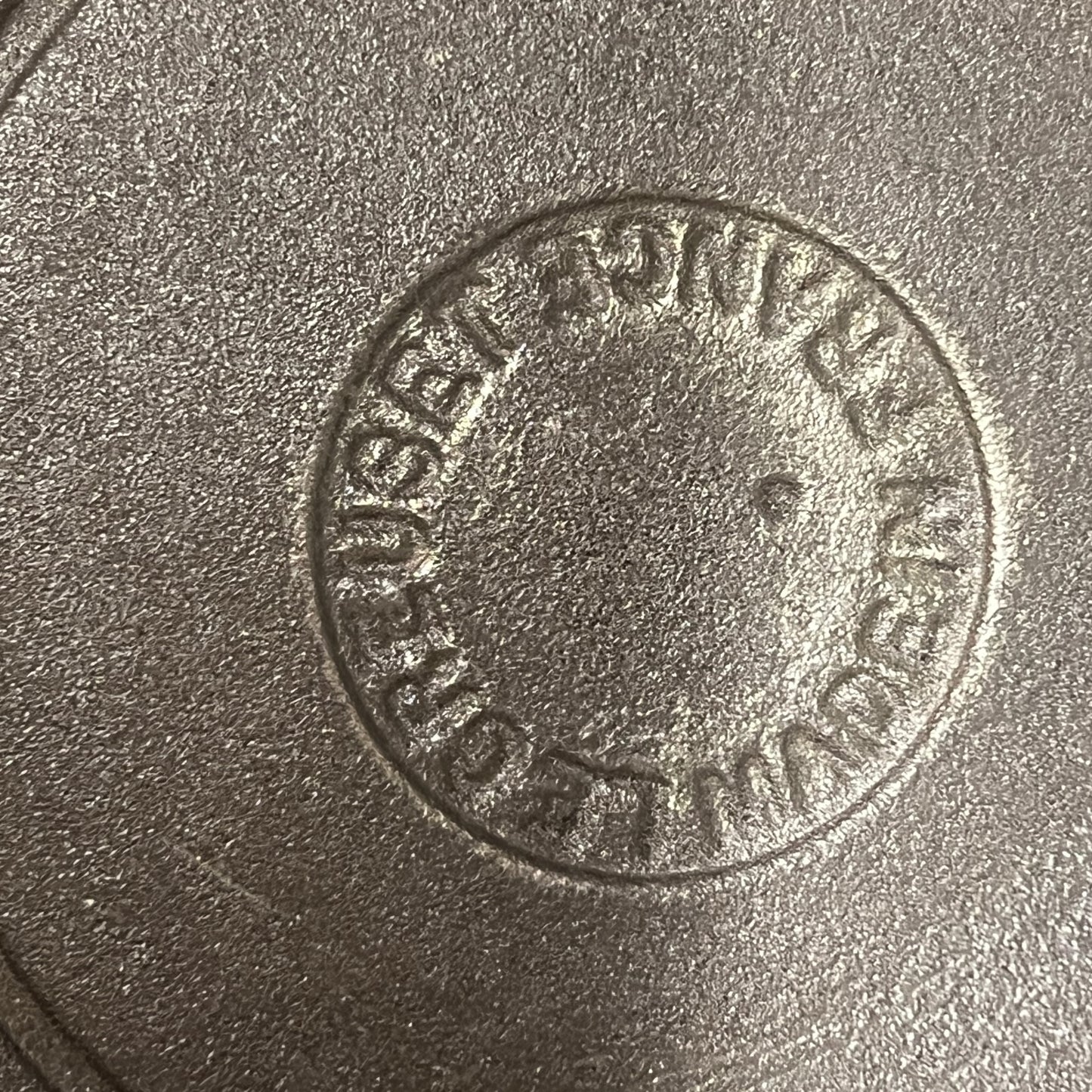 Base view of a le Creuset pan showing the makers mark