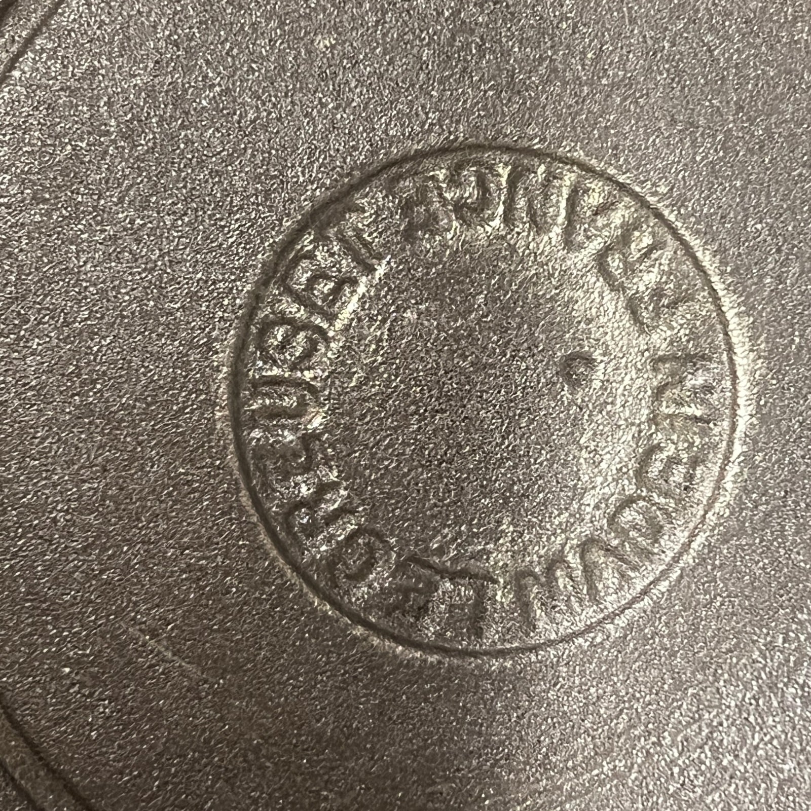 Base view of a le Creuset pan showing the makers mark