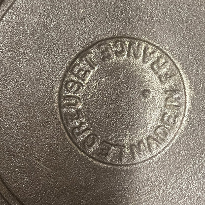 Base view of a le Creuset pan showing the makers mark