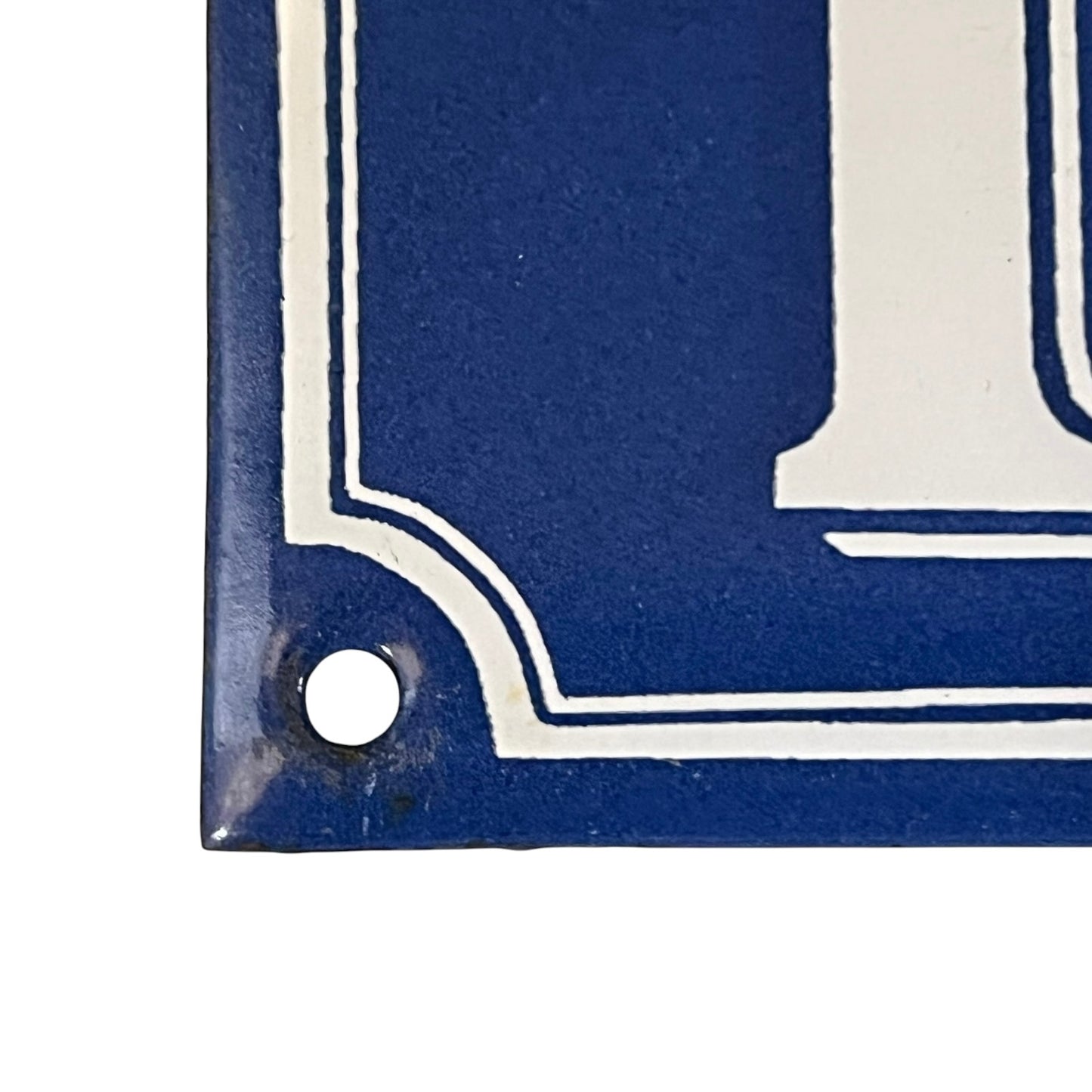 Close up of a blue French metal house number plate with white numbers '111' on a white background