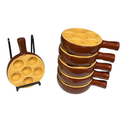 Set of 6 brown ceramic escargots dishes with handles and a pale interior, on a white background.