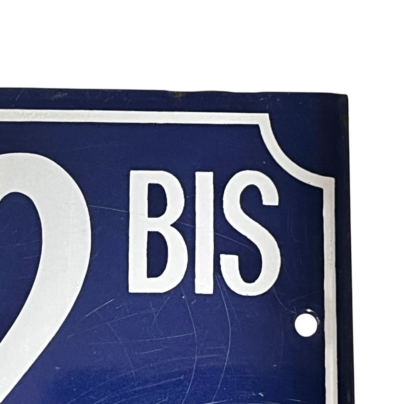 Close up of a French enamel door number 32 on a white background 