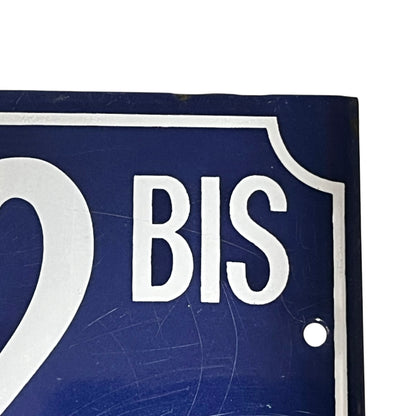 Close up of a French enamel door number 32 on a white background 