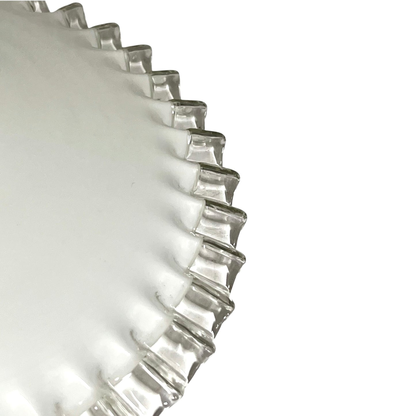 Close-up of a clear glass lampshade with a fluted, scalloped rim on a plain white background.