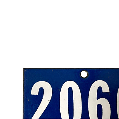 A close-up of a blue rectangular sign or plaque with large white numerals '206' and a small round hole near the top, shown against a white background.