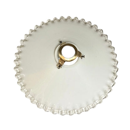 French vintage milk glass opaline lampshade with a clear trimmed frilly edge and a brass bulb holder ideal for a French country style set on a white background
