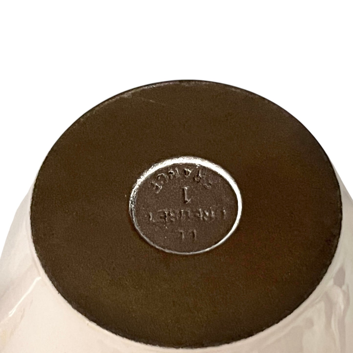 Close up of a fondue pan on a white background