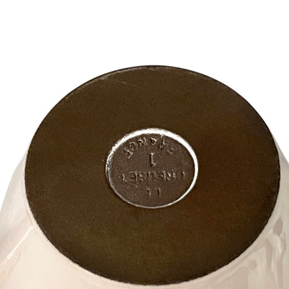 Close up of a fondue pan on a white background