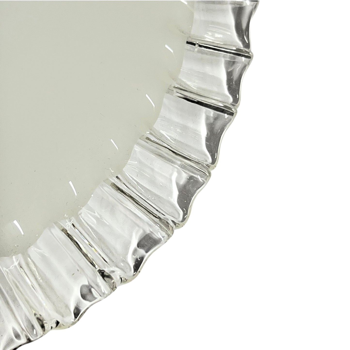 Close-up of a milk glass lampshade with a fluted, ruffled edge on a white background.