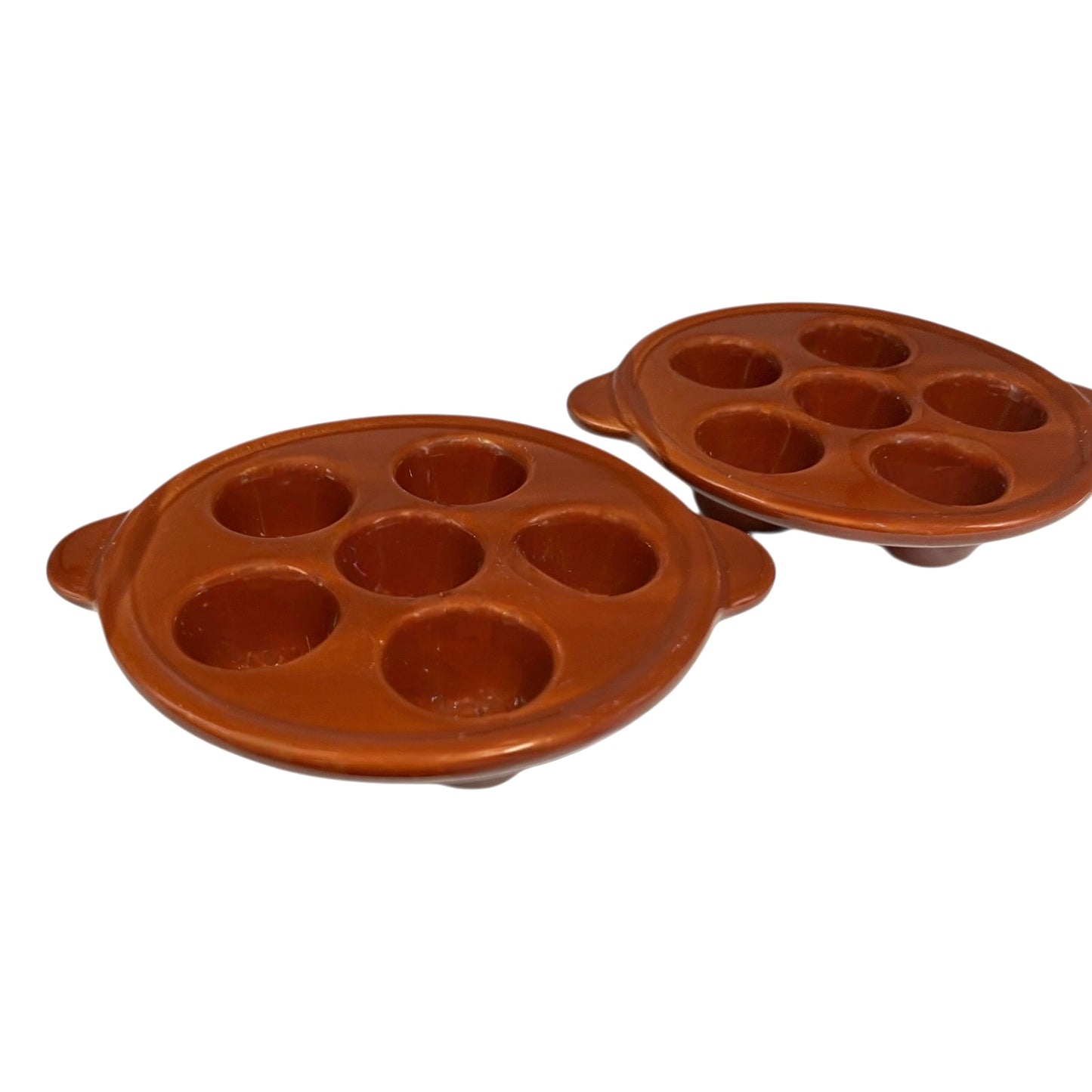 Brown ceramic egg ,snail, or escargots plates with multiple compartments on a white background