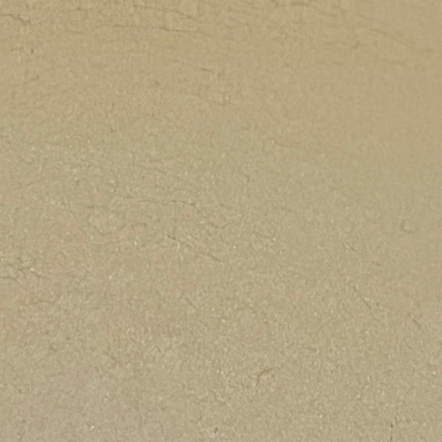Close up of Le Creuset dish with beige interior on a white background