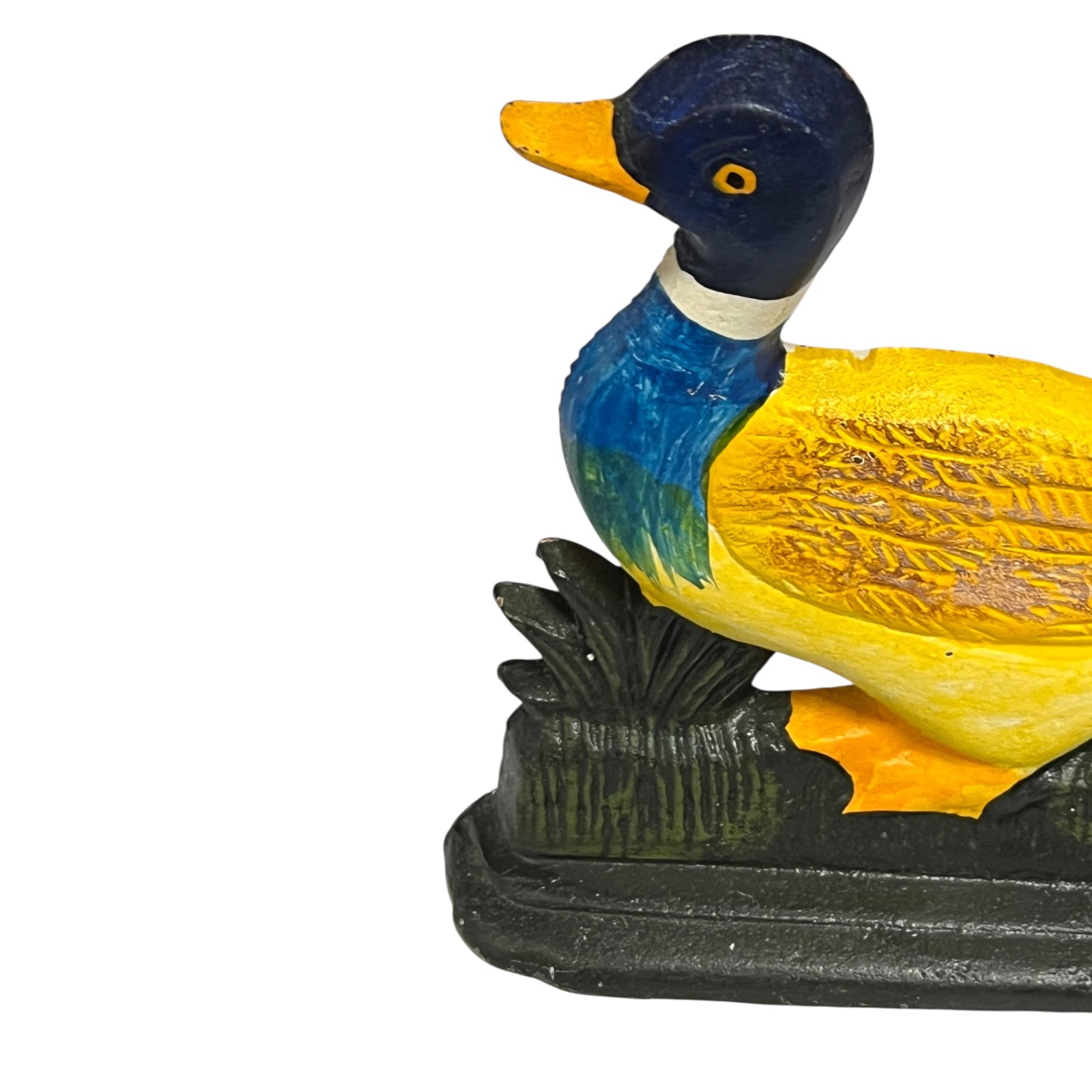Colourful cast iron duck doorstop on a white background